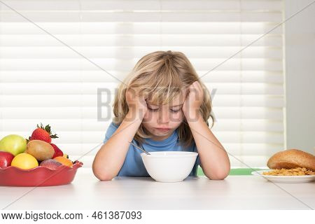 Portrait Of Child With No Appetite. Concept Of Loss Of Appetite. Kid Bot Eating Meal. Healthy Nutrit