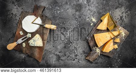 Piece Of Parmesan Cheese And Assortment Of Different Cheeses Dor Blu, Camamber Brie With Knife On A 