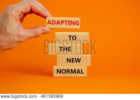 Adapting To The New Normal Symbol. Wooden Blocks With Words Adapting To The New Normal On Beautiful 