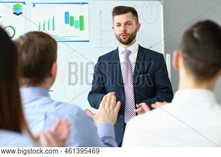 Male Business Coach Speaker In Suit Makes Presentation. Speaker Leader Advises On Training Persuadin