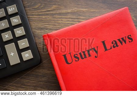 Usury Laws Book Near A Dark Calculator.