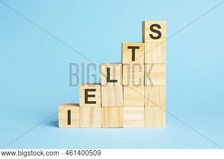 The Word Ielts Is Written On A Wooden Cubes. Blocks On A Bright Blue Background