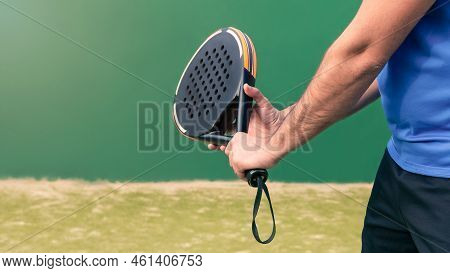 Professional Monitor Of Padel Holding Black Racket On Green Court. Game Concept