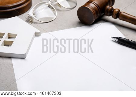 Last Will And Testament Near House Figure, Glasses And Gavel On Light Grey Table, Closeup