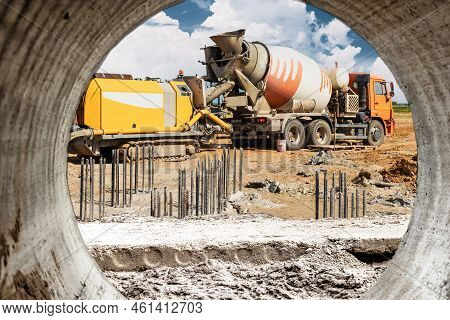 Concrete Mixer Truck Delivers Concrete To The Pump For Pouring Piles. Concrete Pump At The Construct