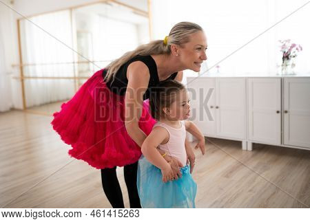 Little Girl With Down Syndrome Learning Ballet With Dance Lecteur In Ballet Studio.