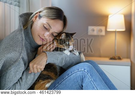 Young Woman Hugs Domestic Pet Enjoying Spending Time With Favourite Cat. Animal Makes Owner Happy An