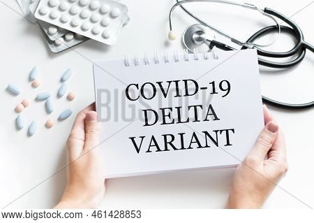 Doctor's Hand In Blue Glove With White Paper And Text Covid-19 Delta Variant With Various Protection