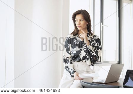 Shot Of Confident Businesswoman Feeling Stress While Sitting In A Modern Office And Working On Lapto