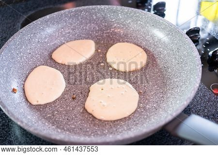 Frying Small Pancakes On A Kefir Base In A Frying Pan.