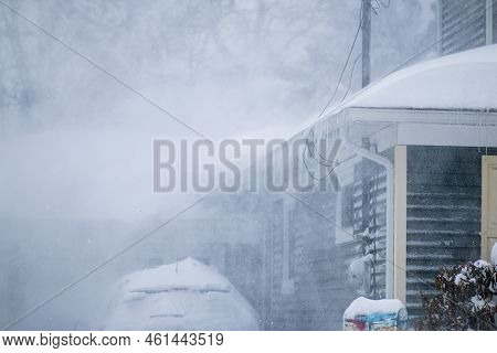 Snow Blowing Off The Roof Of A Residential House During A Blizzard On Long Island New York.