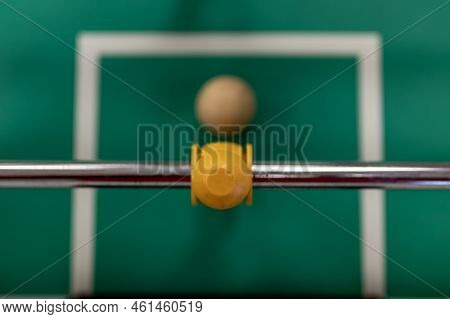 Selective Focus Top View On A Foosball Goalie Blocking The Ball Insider The Box.