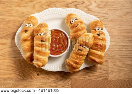 Fun Food For Kids. Mummy Sausages Scary Halloween Party Food Decoration Wrapped In Dough With A Bowl