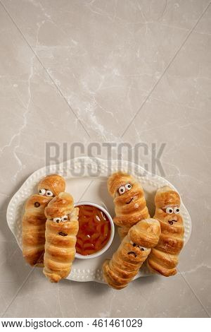 Fun Food For Kids. Mummy Sausages Scary Halloween Party Food Decoration Wrapped In Dough With A Bowl