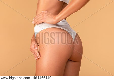 Slim Millennial Woman In White Underwear Toucing Her Hip, Satisfied With Result Of Healthy Diet Or E