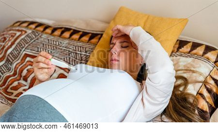 Pregnancy Fever Temperature Check. Pregnant Woman Holding Thermometer, Check Fever Flu Temperature. 
