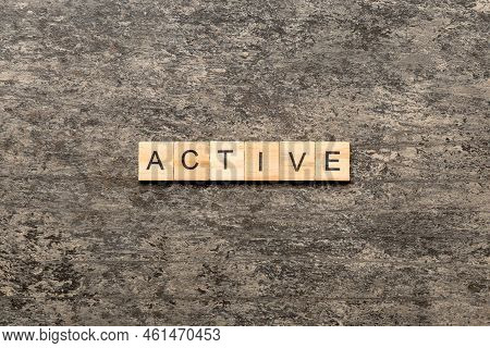 Active Word Written On Wood Block. Active Text On Table, Concept.