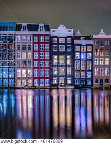 Amsterdam At Night With Dancing Colorful House At The Amsterdam Canals