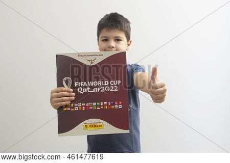 Bauru, Brazil - 12.09.22: Front View Of Cute Boy Smiling And Holding Qatar 2022 World Cup Album - Fi