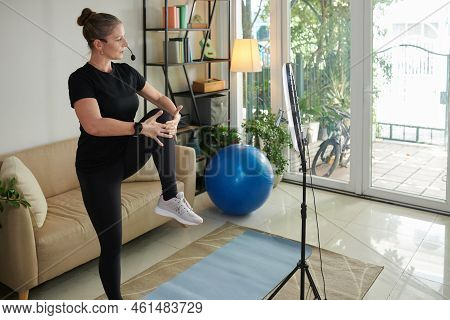 Sportswoman Recording Herself Working Out At Home In The Morning