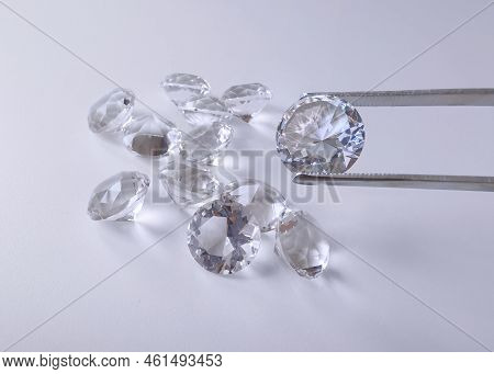 Brilliant Cut Diamond Held By Tweezers. For Design