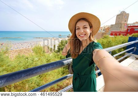 Young Beautiful Woman Smiling Happy Takes Selfie By Smartphone Camera In Termoli Village, Italy