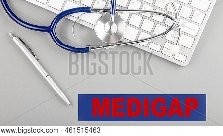 Medigap Word With Stethoscope On A Keyboard On Grey Background
