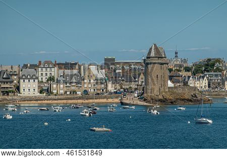 St. Malo, Brittany, France - July 8, 2022: Red Palace With Tower, Frieze And Clock Behind La Tour So
