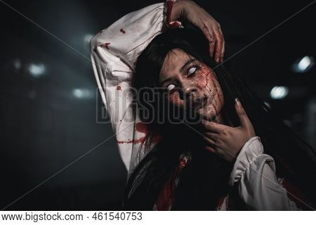 Screaming Zombie Female Face With Blood Grabs Her Head To Twist It Off, Horror Bloodthirsty Woman Gh