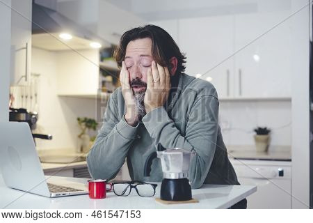 Tired Man At Home In Morning Wake Up Activity Touching Face And Stretching After Bad Rest Night. Cof