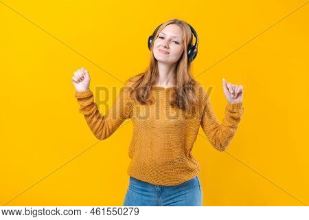 Woman Dancing To Music While Listening To Mp3 Player With Wired Headphones. Energy Move Of Caucasian