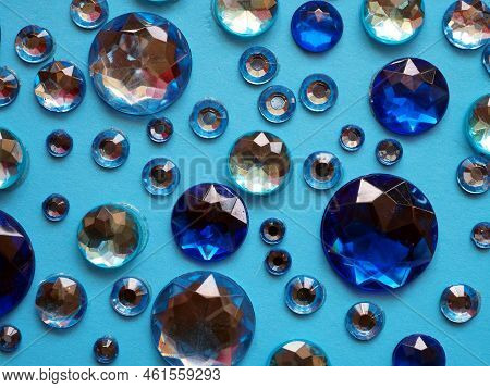Decorative Backdrop For Design: Multifaceted Blue Sparkling Crystals On A Light Blue Background.