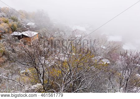 Snow-covered Trees And Rooftops In Gunib Village, Dagestan, Russia. The Famous Town In The Fog In Th