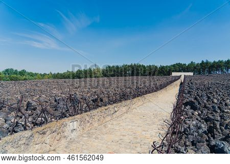08.27.2022 - Belzec, Poland - Belzec Nazi Death Camp. Stone Path In Between Walls Of Former Nazi Dea