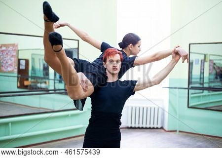 Pair Of Professional Dancers Doing Difficult Trick Or Gimmick In The Dancing Studio. Male And Female