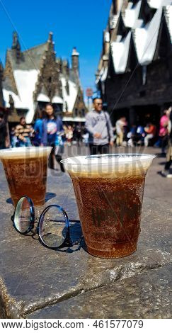 Osaka, Japan On April 10, 2022. Butterbeer Drink In A Plastic Cup On A Blurred Background. This Drin