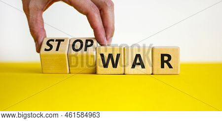 Stop War Symbol. Businessman Turns Cubes And Changes Concept Words War To Stop War. Beautiful Yellow
