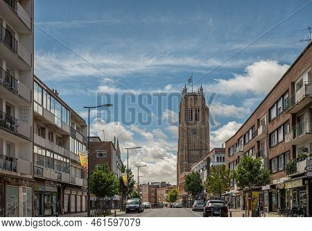Europe, France, Dunkerque - July 9, 2022: Brown Stone Saint Eloi Belfry Towers Over Rue Clemenceau S