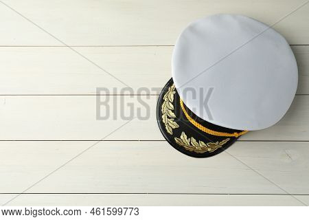 Peaked Cap With Accessories On White Wooden Background, Top View. Space For Text