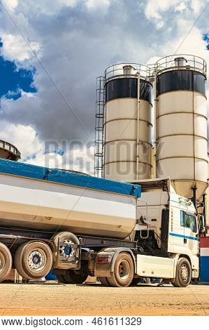 Large Dump Truck Near The Concrete Factory. Car Tonar For Transportation Of Heavy Bulk Cargo. Provis