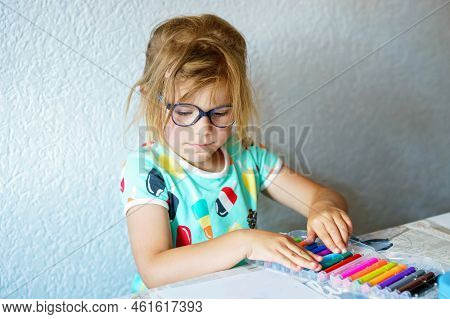 Happy Preschool Girl With Glasses Learning Painting With Colorful Pencils And Felt Pens. Little Todd