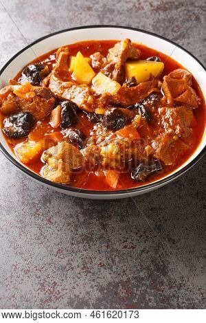 Persian Plum Stew Khoresht Aloo With Lamb Closeup In The Bowl On The Table. Vertical