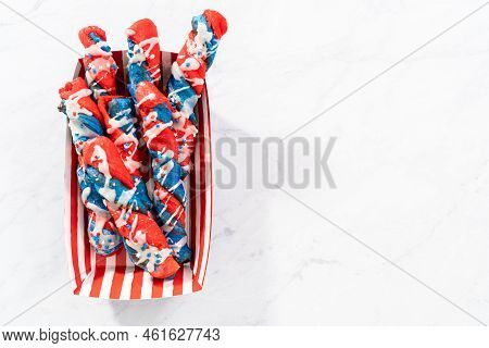 Patriotic Cinnamon Twists Drizzled With A White Glaze And Decorated With Star Sprinkles.