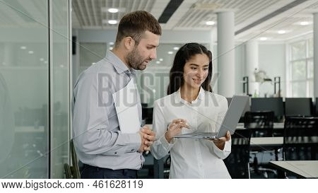 Positive Friendly Colleagues Chatting In Office Discussing Project Details Young Female Employee Con
