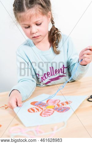 Little Girl Learning How To Sew With Sewing Craft Kit For Kids.