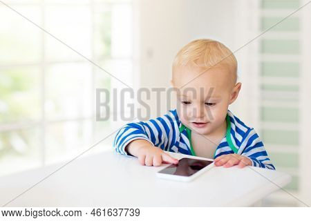 Baby Boy With Mobile Phone. Little Child Trying To Play With Cell Phone. First Educational Game Apps