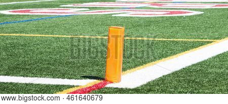 Orange Pylon Marking The End Zone For A Football Game On Q Green Turf Field.