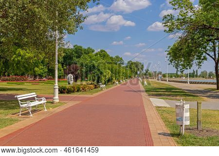 Palic, Serbia - August 01, 2022: Red Walking Path At Green Park Lake Palic Hot Summer Day.