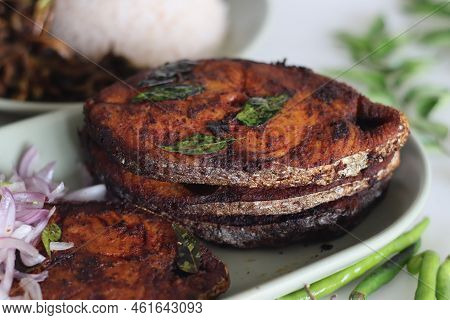 Crispy Surmai Fish Fry. Shallow Fried King Fish In Kerala Style Served With Onion Tomato Salad Calle