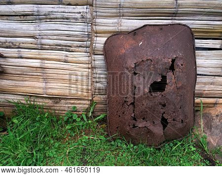A Very Old And Rusty Wheelbarrow Laying Against A Cane Wall In A Farm Near The Colonial Town Of Vill